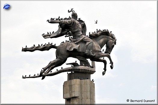 Bishkek, statue of Manas struggling against a dragon and a lot of pigeons